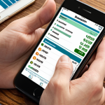 **A visual representation of budgeting and tracking finances using a mobile app on a smartphone, depicting a person reviewing their expenses and identifying areas for saving. The scene should evoke a sense of financial awareness and control.**
